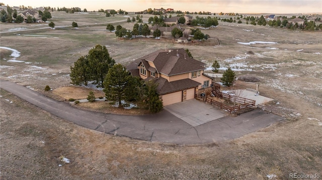 aerial view at dusk featuring a rural view