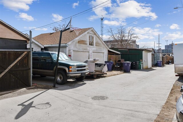 4445 Pearl St, Denver, CO 80216 - view of property exterior with an outbuilding and a shingled roof