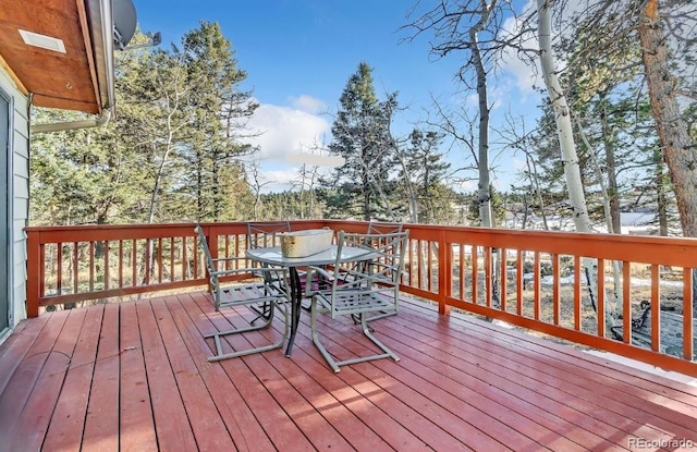 deck with outdoor dining area