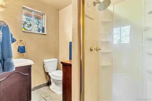 bathroom featuring vanity, a shower with shower door, tile patterned floors, and toilet