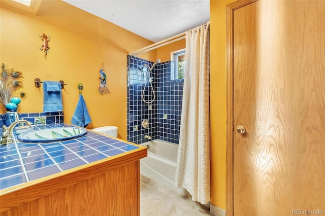 full bathroom featuring tile patterned floors, a sink, toilet, and shower / tub combo with curtain