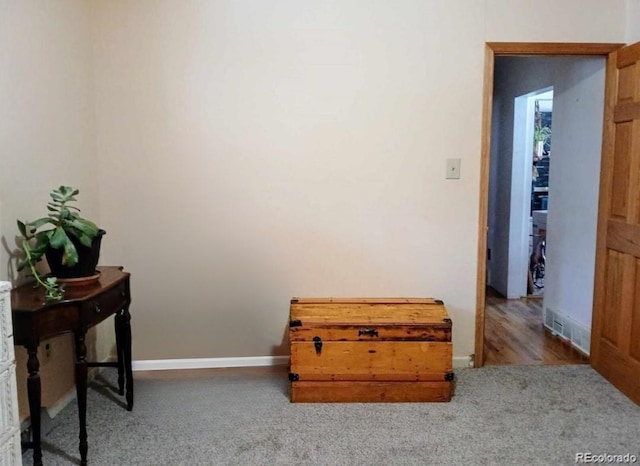 interior space with carpet and baseboards