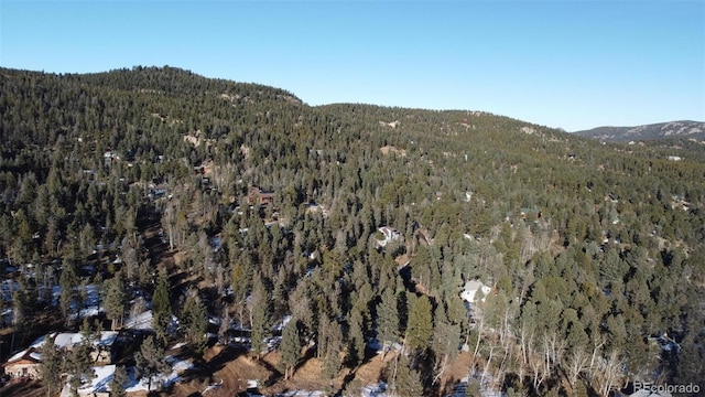 bird's eye view featuring a wooded view and a mountain view