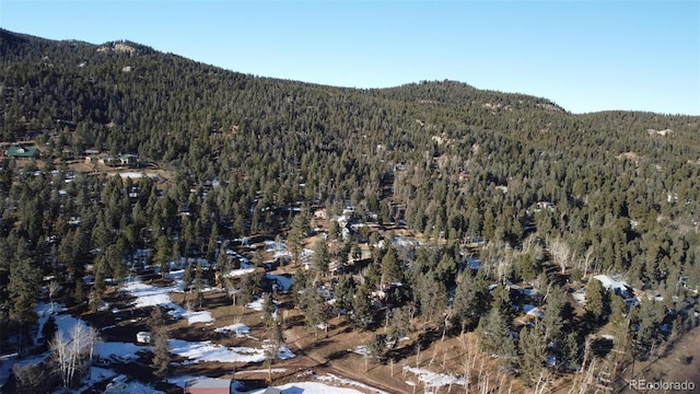 aerial view with a mountain view and a view of trees