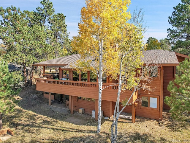 back of house with a wooden deck