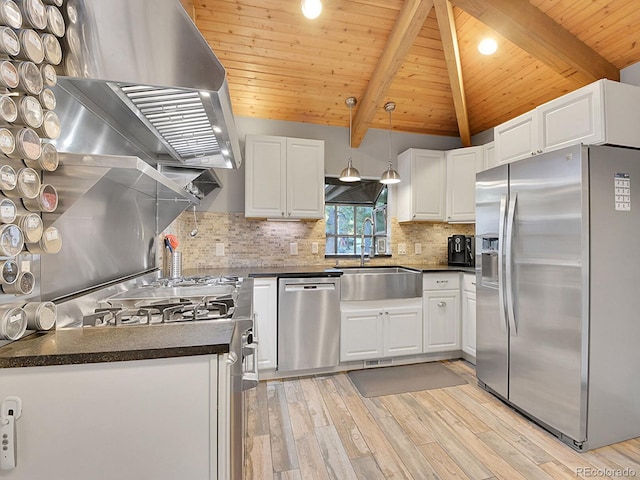 kitchen featuring white cabinets, appliances with stainless steel finishes, light wood-type flooring, pendant lighting, and lofted ceiling with beams