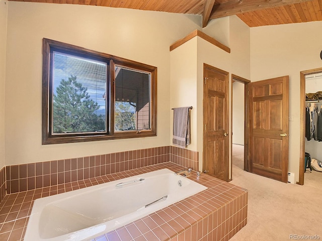 bathroom featuring wooden ceiling, vaulted ceiling with beams, and tiled tub