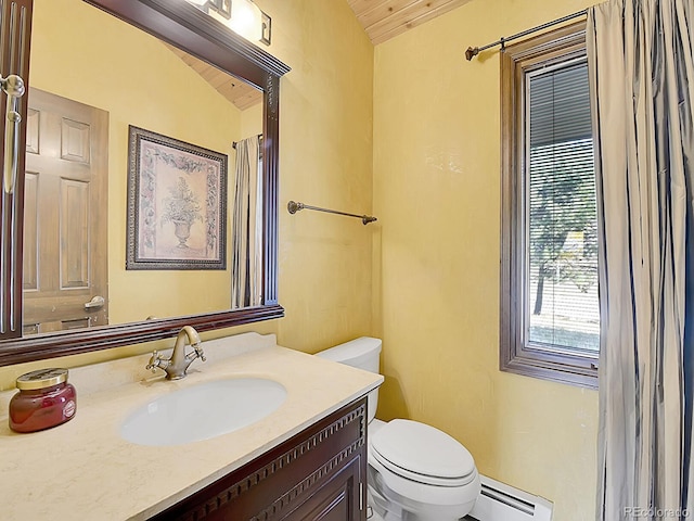 bathroom featuring toilet, lofted ceiling, baseboard heating, and vanity