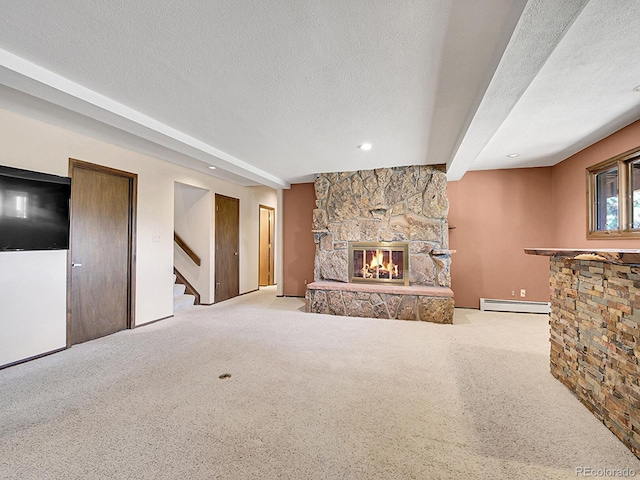 carpeted living room with a stone fireplace, a textured ceiling, a baseboard radiator, and beamed ceiling