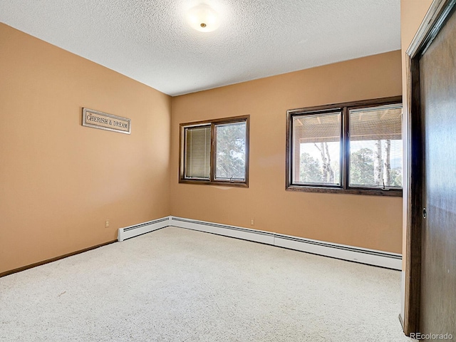 spare room featuring baseboard heating and a textured ceiling