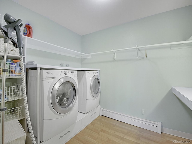 washroom featuring independent washer and dryer, baseboard heating, and light hardwood / wood-style floors