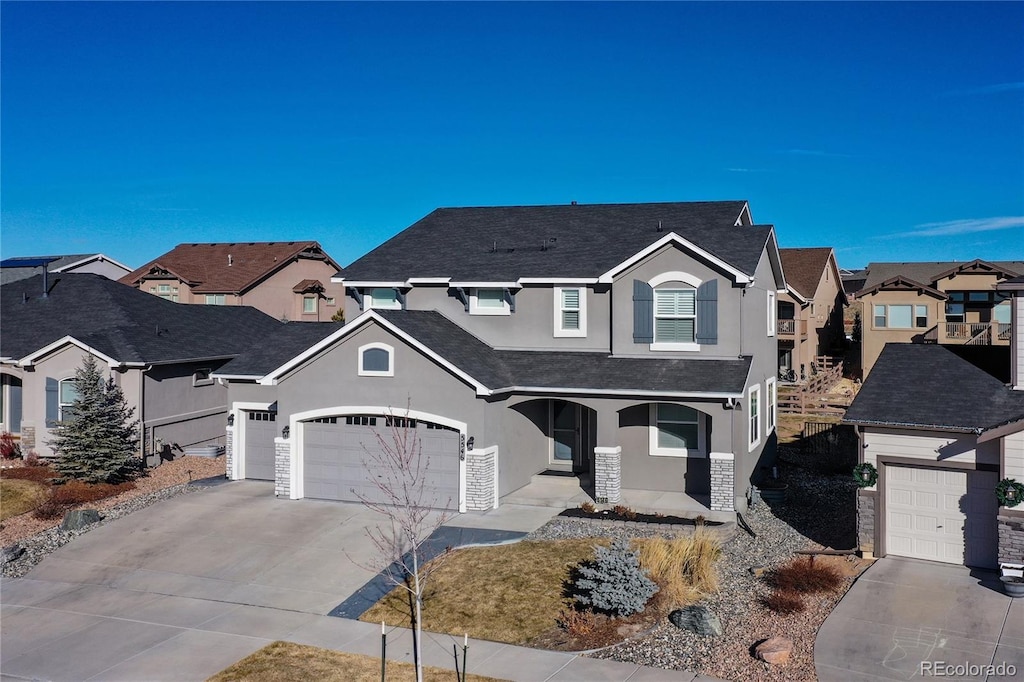 front of property featuring a garage and covered porch