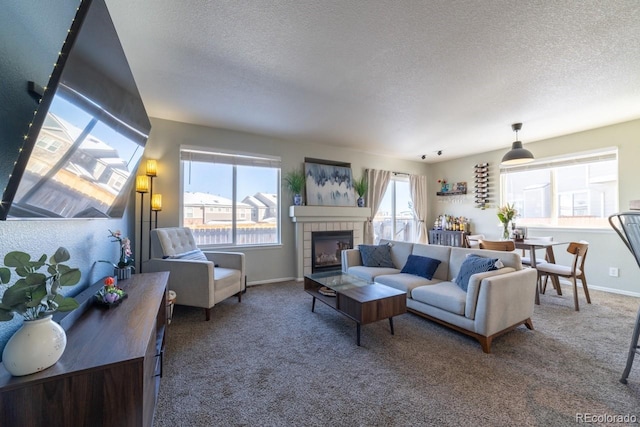 living room with carpet flooring, a tile fireplace, and a textured ceiling