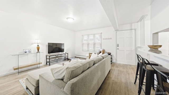 677 Vrain St Unit 15, Denver, CO 80204 - living room featuring wood finished floors, baseboard heating, and baseboards