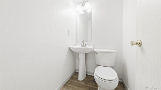 677 Vrain St Unit 15, Denver, CO 80204 - bathroom featuring baseboards, wood finished floors, and toilet