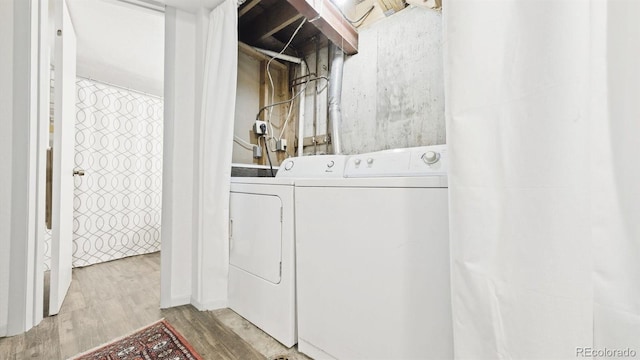 677 Vrain St Unit 15, Denver, CO 80204 - laundry room with independent washer and dryer and wood finished floors