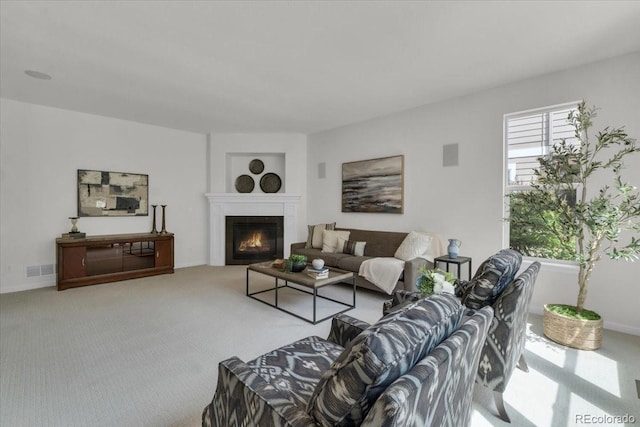 10683 Amesbury Way, Highlands Ranch, CO 80126 - living area featuring a lit fireplace, carpet flooring, and built in features