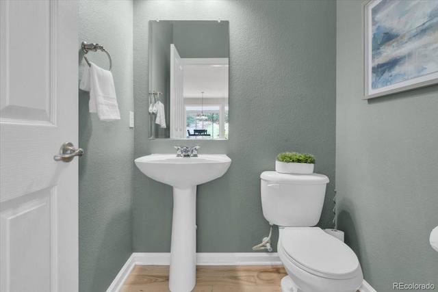 10683 Amesbury Way, Highlands Ranch, CO 80126 - half bathroom with a textured wall and wood finished floors