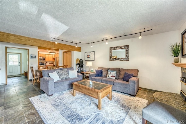 23004 US Highway 6 Unit 103, Dillon, CO 80435 - living area featuring rail lighting and a textured ceiling