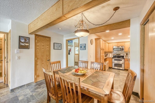 23004 US Highway 6 Unit 103, Dillon, CO 80435 - dining room featuring a textured ceiling and beam ceiling