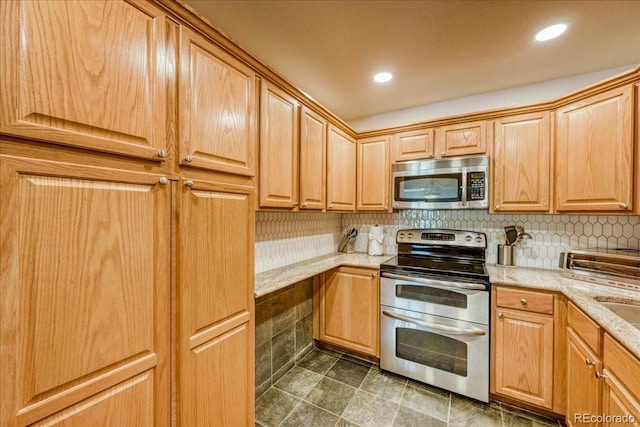 23004 US Highway 6 Unit 103, Dillon, CO 80435 - kitchen featuring appliances with stainless steel finishes, light stone counters, backsplash, and recessed lighting