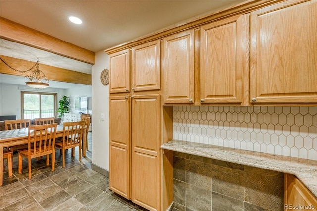 23004 US Highway 6 Unit 103, Dillon, CO 80435 - kitchen with tasteful backsplash, recessed lighting, light stone counters, decorative light fixtures, and light brown cabinetry