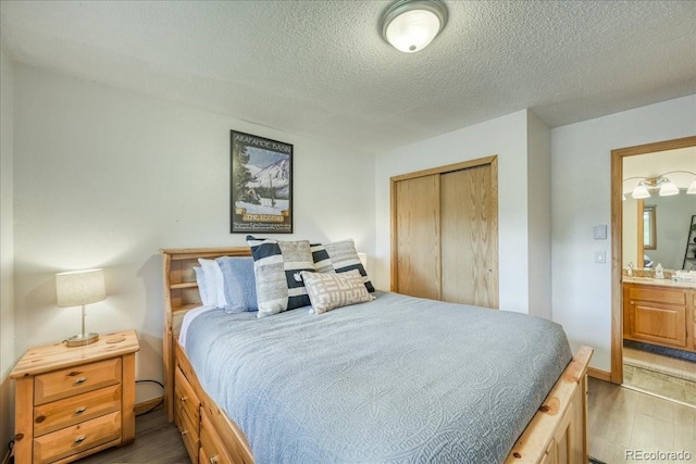 23004 US Highway 6 Unit 103, Dillon, CO 80435 - bedroom featuring wood finished floors, a textured ceiling, and a closet