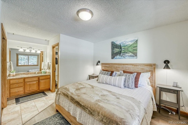 23004 US Highway 6 Unit 103, Dillon, CO 80435 - bedroom with a textured ceiling, a chandelier, and ensuite bathroom