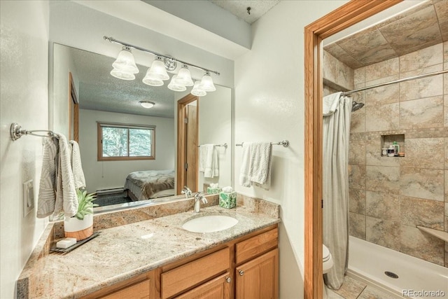 23004 US Highway 6 Unit 103, Dillon, CO 80435 - ensuite bathroom featuring vanity, a tile shower, and a textured ceiling