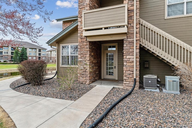 2824 W Centennial Dr Unit L, Littleton, CO 80123 - entrance to property with central air condition unit and stone siding