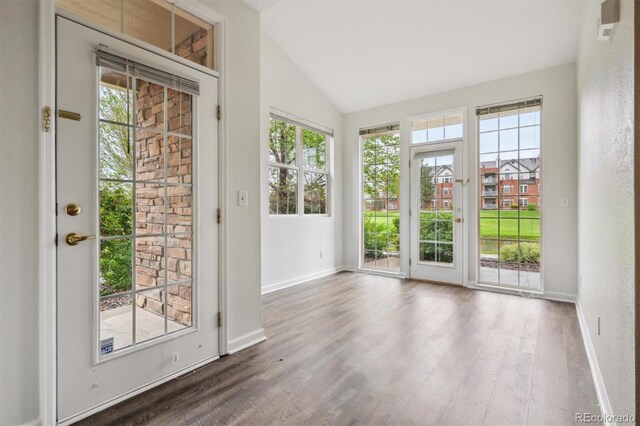 2824 W Centennial Dr Unit L, Littleton, CO 80123 - doorway with lofted ceiling, dark wood-type flooring, and baseboards
