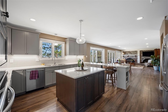 5 Sanford Rd, Colorado Springs, CO 80906 - kitchen with a sink, dishwasher, stove, gray cabinetry, and a peninsula