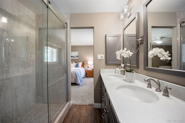 5 Sanford Rd, Colorado Springs, CO 80906 - ensuite bathroom featuring wood finished floors, a stall shower, and double vanity