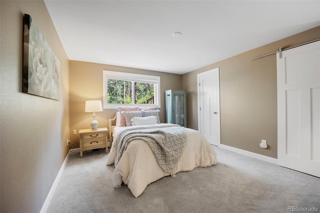 5 Sanford Rd, Colorado Springs, CO 80906 - bedroom with baseboards, carpet flooring, and a barn door