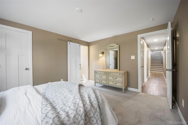 5 Sanford Rd, Colorado Springs, CO 80906 - bedroom with light colored carpet, baseboards, and a barn door