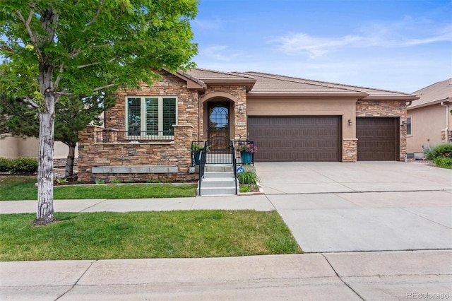 8070 W Progress Cir, Littleton, CO 80123 - view of front of house with stone siding, an attached garage, concrete driveway, a tiled roof, and stucco siding