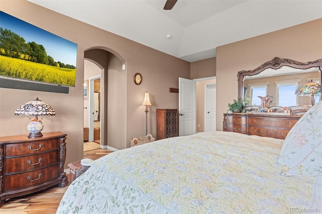 8070 W Progress Cir, Littleton, CO 80123 - bedroom featuring light wood-type flooring, arched walkways, and ceiling fan