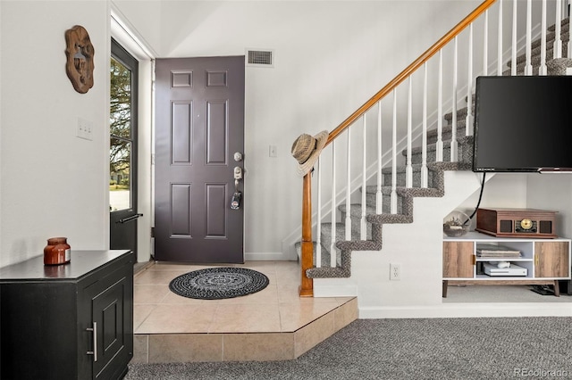 4713 Perth St, Denver, CO 80249 - foyer entrance featuring stairs, tile patterned floors, and baseboards
