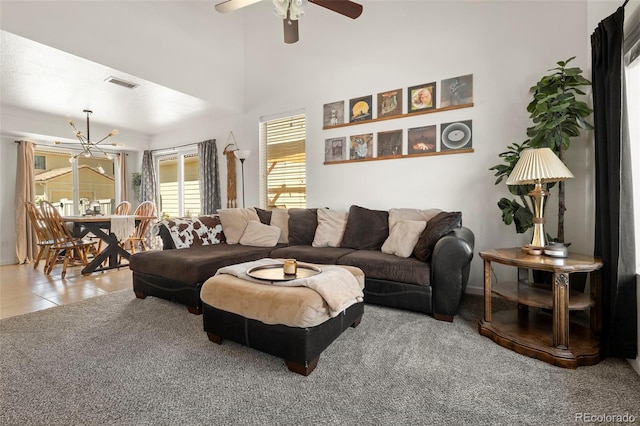 4713 Perth St, Denver, CO 80249 - carpeted living room with a ceiling fan, a chandelier, baseboards, and tile patterned flooring