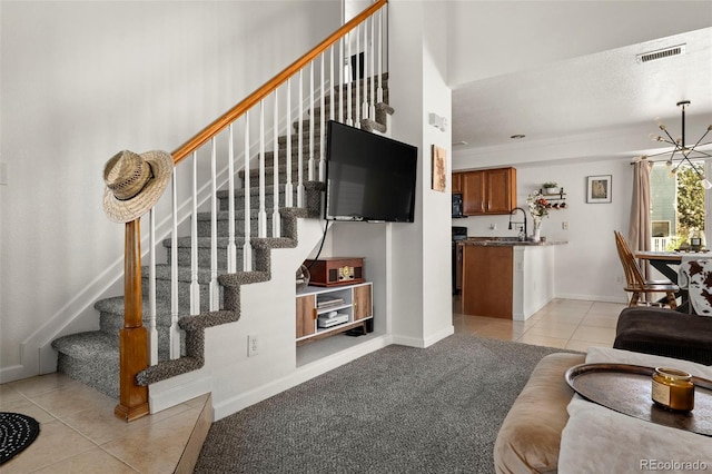 4713 Perth St, Denver, CO 80249 - living area featuring light tile patterned floors, stairs, a chandelier, and baseboards