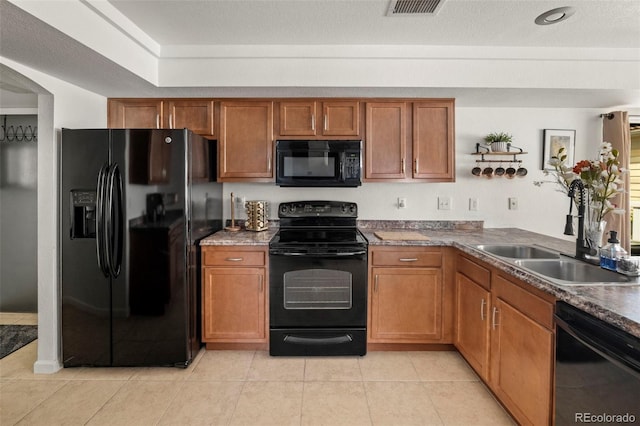 4713 Perth St, Denver, CO 80249 - kitchen with black appliances, a sink, and brown cabinetry