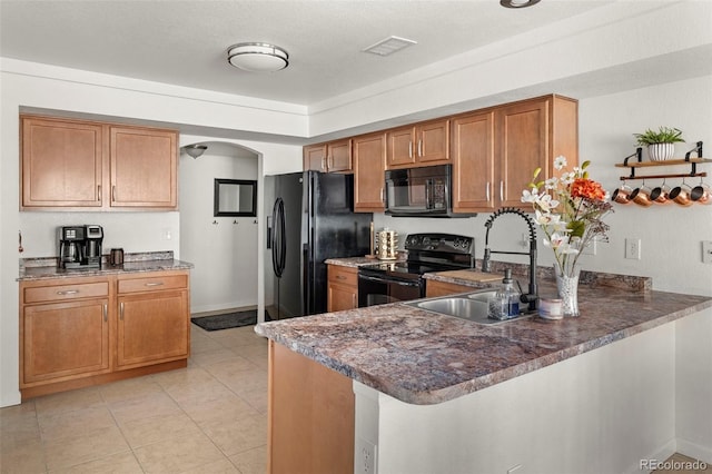 4713 Perth St, Denver, CO 80249 - kitchen featuring black appliances, brown cabinetry, arched walkways, a sink, and a peninsula
