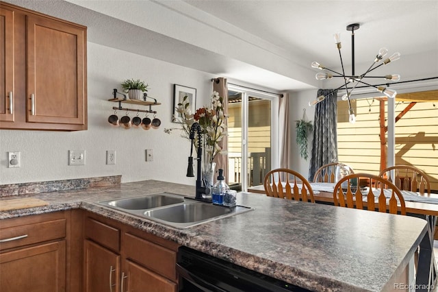 4713 Perth St, Denver, CO 80249 - kitchen with a sink, a chandelier, brown cabinetry, a peninsula, and dark countertops