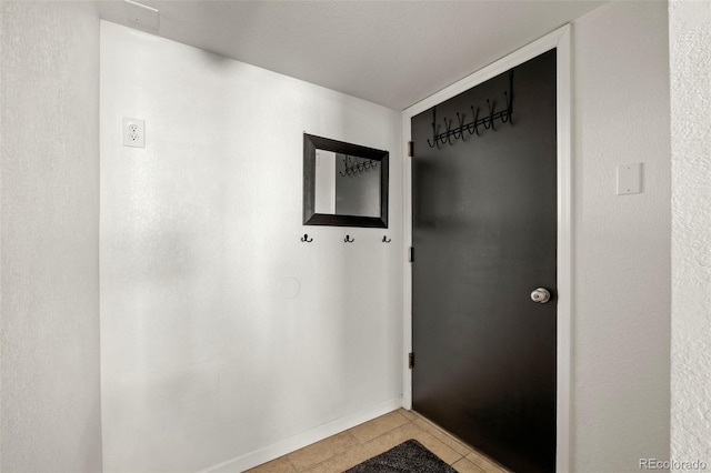 4713 Perth St, Denver, CO 80249 - doorway to outside featuring light tile patterned flooring and baseboards