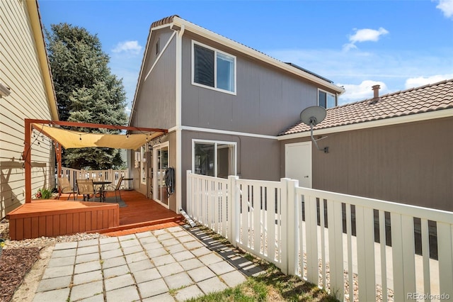 4713 Perth St, Denver, CO 80249 - back of house featuring a wooden deck, fence, outdoor dining space, and a tiled roof