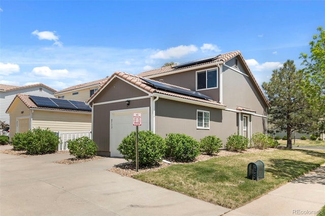 4713 Perth St, Denver, CO 80249 - traditional-style house featuring roof mounted solar panels, an attached garage, a front lawn, stucco siding, and concrete driveway