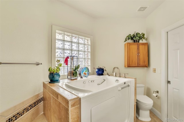 bathroom with a washtub and toilet