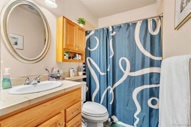 bathroom featuring vanity and toilet