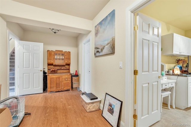 corridor with light hardwood / wood-style floors