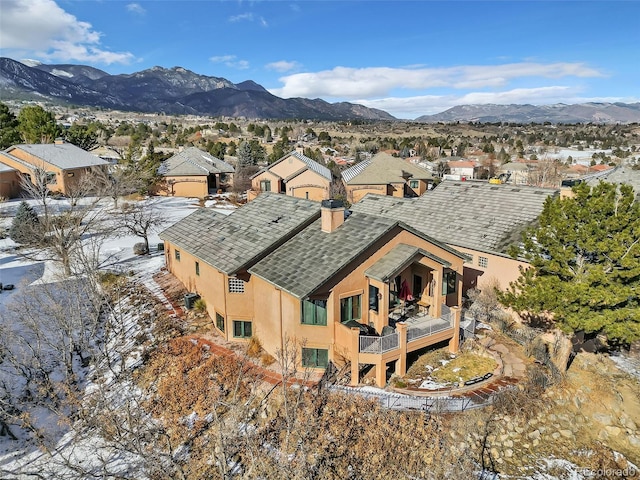 snowy aerial view with a mountain view